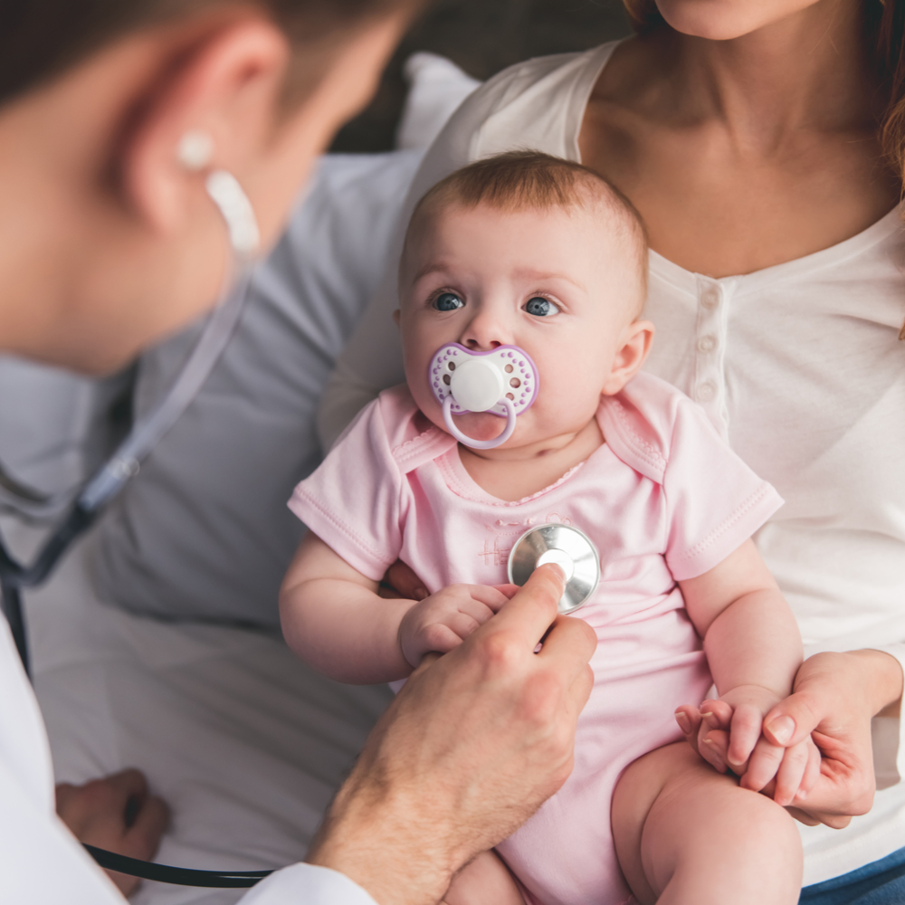 doctor is listening to baby's lungs